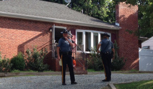 Troopers stand outside front of home where boy was found in water atop pool cover in rear of home on Capitol Trail near Newark. (Photo: Delaware Free News)