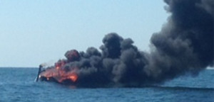 Two people and a dog were rescued after a sailboat caught fire off of Ocean City, New Jersey. (Photo courtesy Coast Guard)