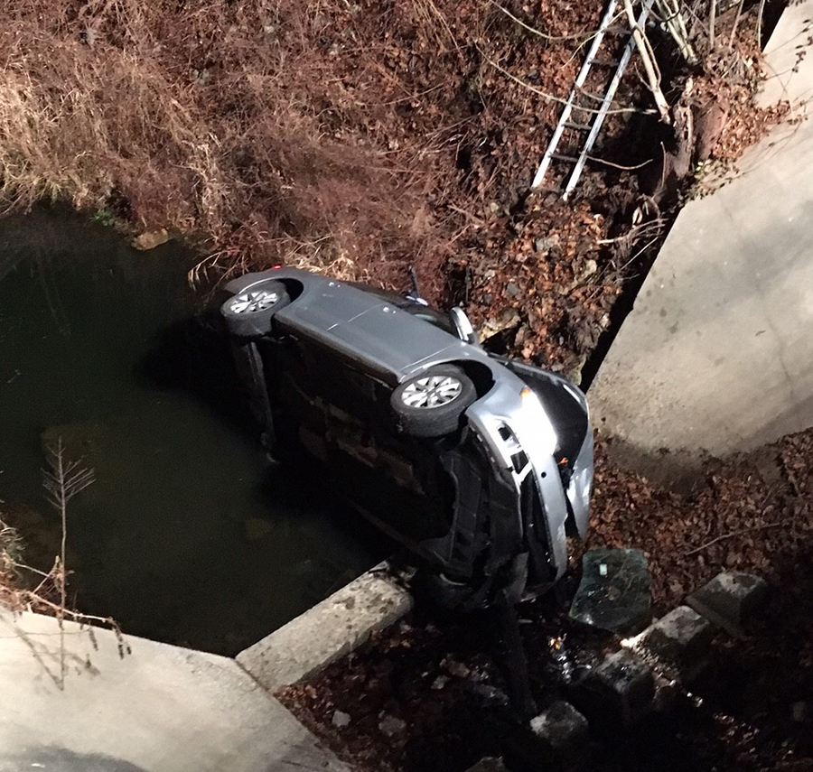 Hockessin and Avondale firefighters extricated driver from car that crashed into spillway at Somerset Lake. (Photo: Delaware Free News)