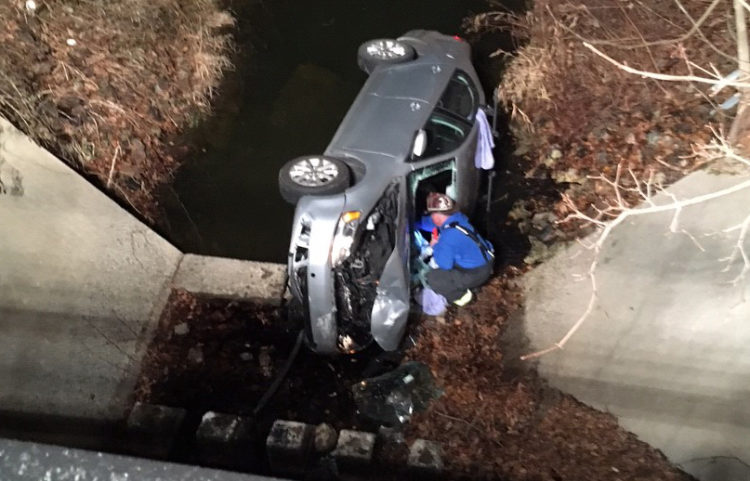 Hockessin and Avondale firefighters extricated driver from car that crashed into spillway at Somerset Lake. (Photo: Delaware Free News)